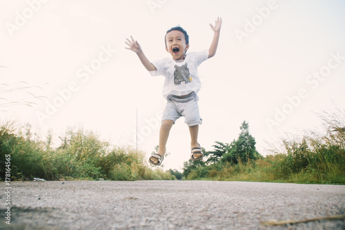 Healthy And Cheerful Asian Kids Is Jumping Happily , Outdoor