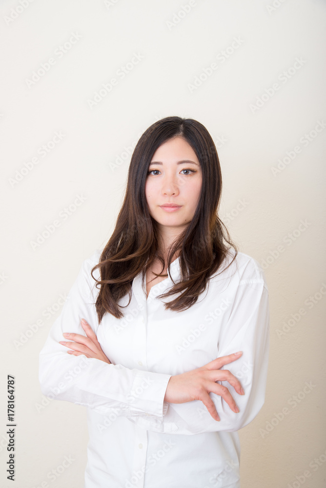 young asian woman with white shirt crossing arms young asian woman with white shirt crossing arms