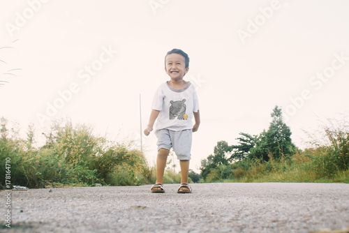 Healthy And Cheerful Asian Kids Is Jumping Happily , Outdoor
