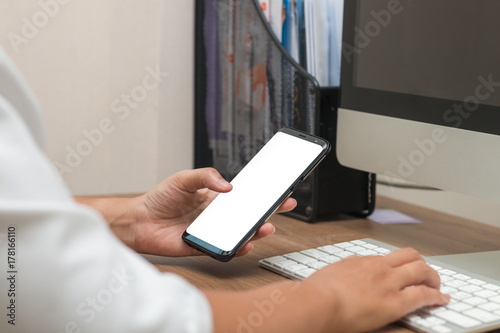 The worker woman touching screen on smart phone and typing keyboard, Busy business concept