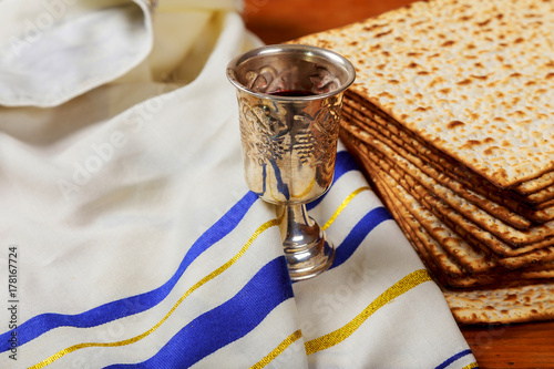 Silver wine cup with matzah, Jewish symbols for the Passover Pesach holiday. Passover concept. photo