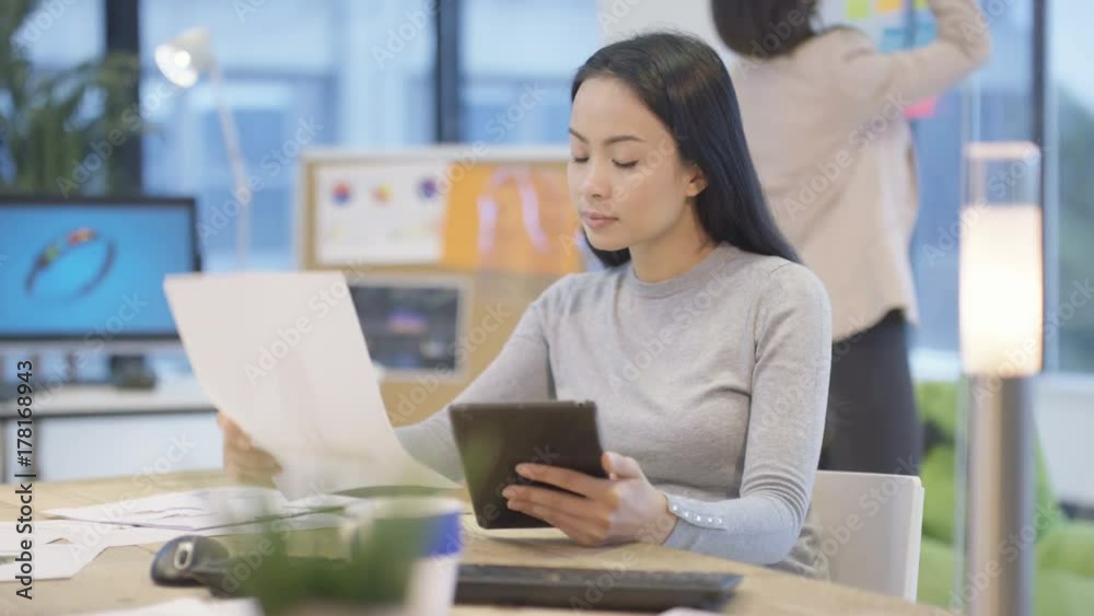 Designers in modern office looking at drawings & discussing ideas Designers in modern office looking at drawings & discussing ideas