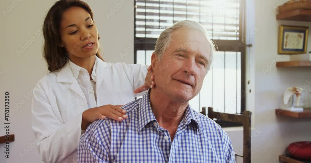 Senior man receiving neck massage from physiotherapist 