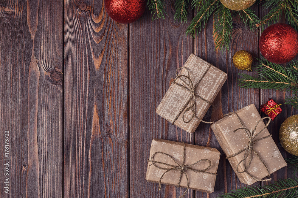 Christmas gift boxes and fir tree on wooden background. Christmas gift boxes and fir tree on wooden background.