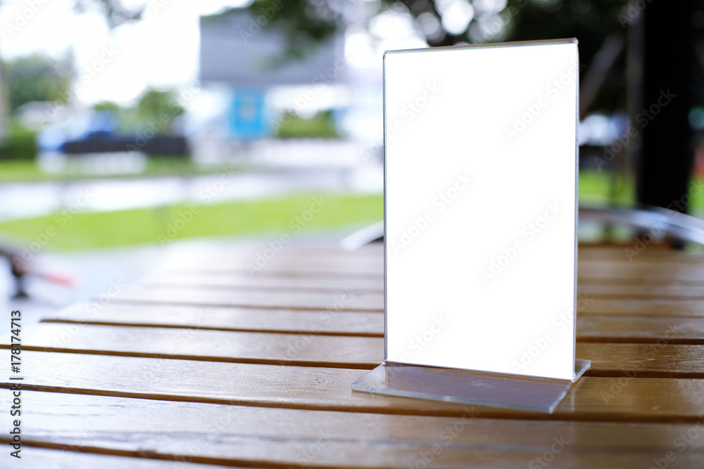 Mock up Menu frame standing on wood table in Bar restaurant cafe. space for text Mock up Menu frame standing on wood table in Bar restaurant cafe. space for text