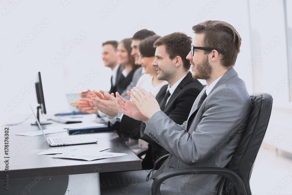 cheering business team sitting at Desk cheering business team sitting at Desk