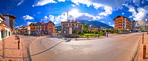 Cortina D' Ampezzo street and Alps peaks panoramic view photo