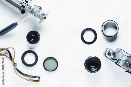 Film camera, lenses and equipment of the photographer on a white background