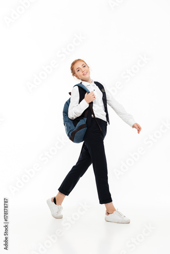 Full length image of smiling gigner student woman with backpack