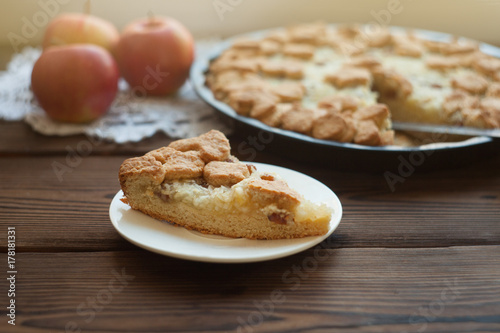 Popular American apple pie piece and cup of tea on wooden table background. Homemade classical fruit tart, Piece of apple pie, close up