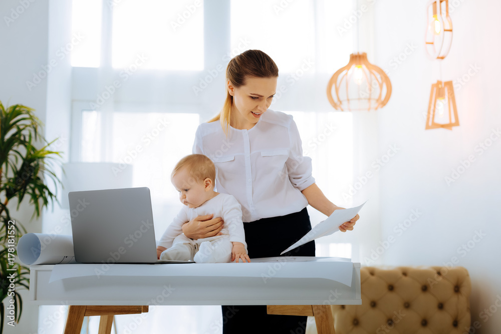 Responsible businesswoman checking the details of a project Responsible businesswoman checking the details of a project