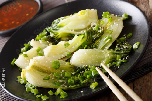 Chinese food: fried bok choy with sesame close-up. horizontal