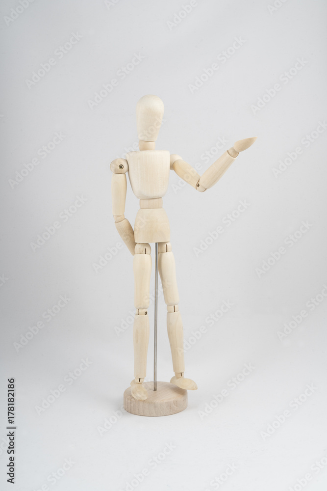 a wooden dummy posing with a hand pointing to the direction a wooden dummy posing with a hand pointing to the direction