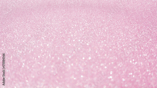 Pink glitter for an abstract background, selective focus.