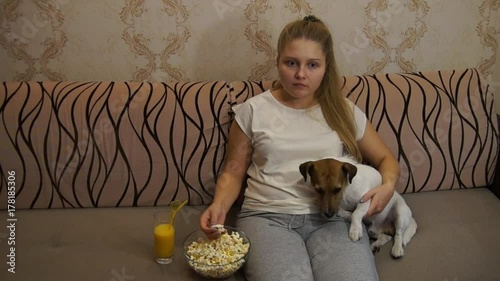 Woman with dog watching tv