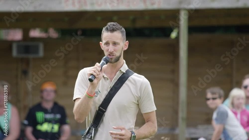  Handler at falconry centre talking to audience during falconry demonstration.