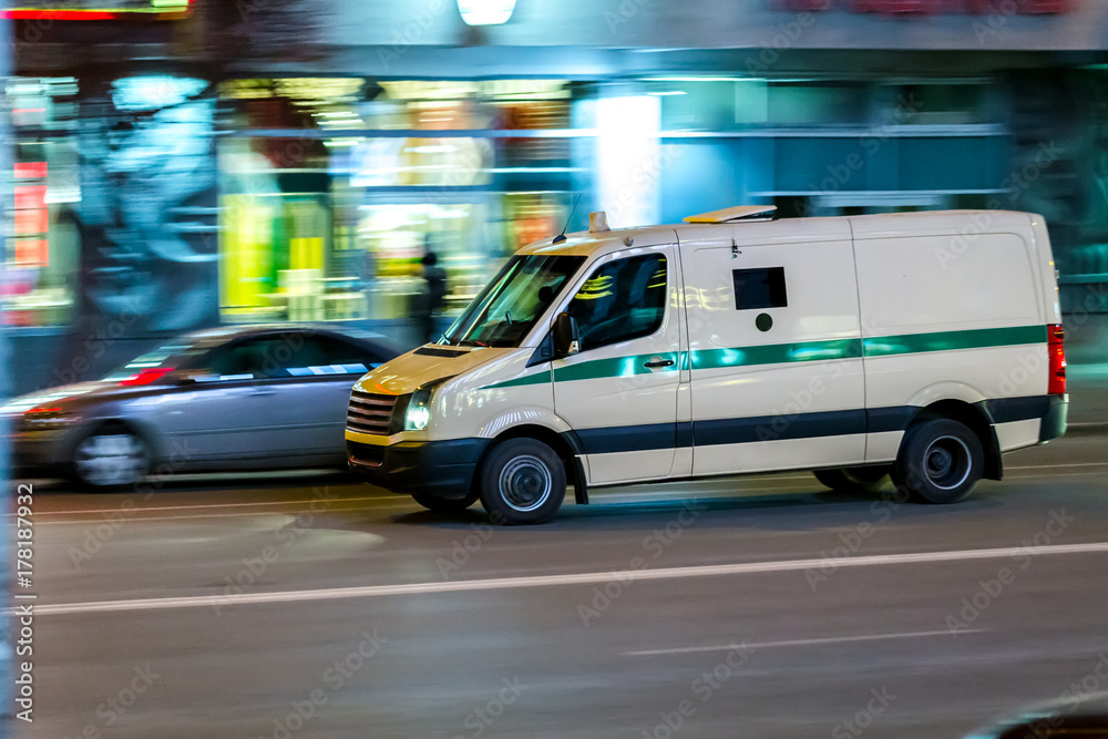 an encashment car in motion in a night city an encashment car in motion in a night city