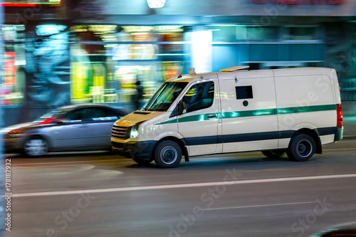 an encashment car in motion in a night city