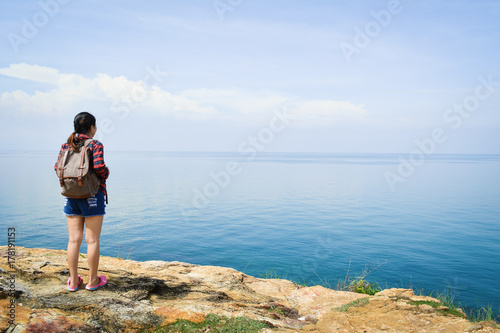 beautiful women backpack standing look at the seaside
