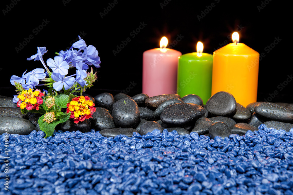 Spa decoration with stones and candles on a black background Spa decoration with stones and candles on a black background