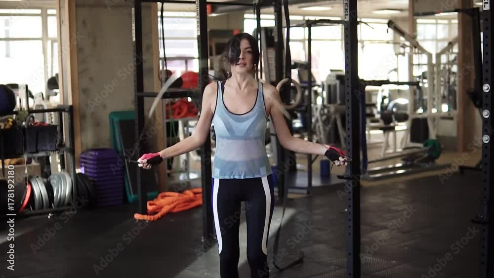 Skipping woman training at the gym working out. Fit young woman skipping rope Skipping woman training at the gym working out. Fit young woman skipping rope
