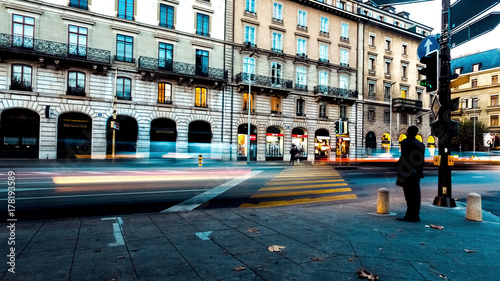 Traffic and people blur on the urban streets in Europe, Switzerland.