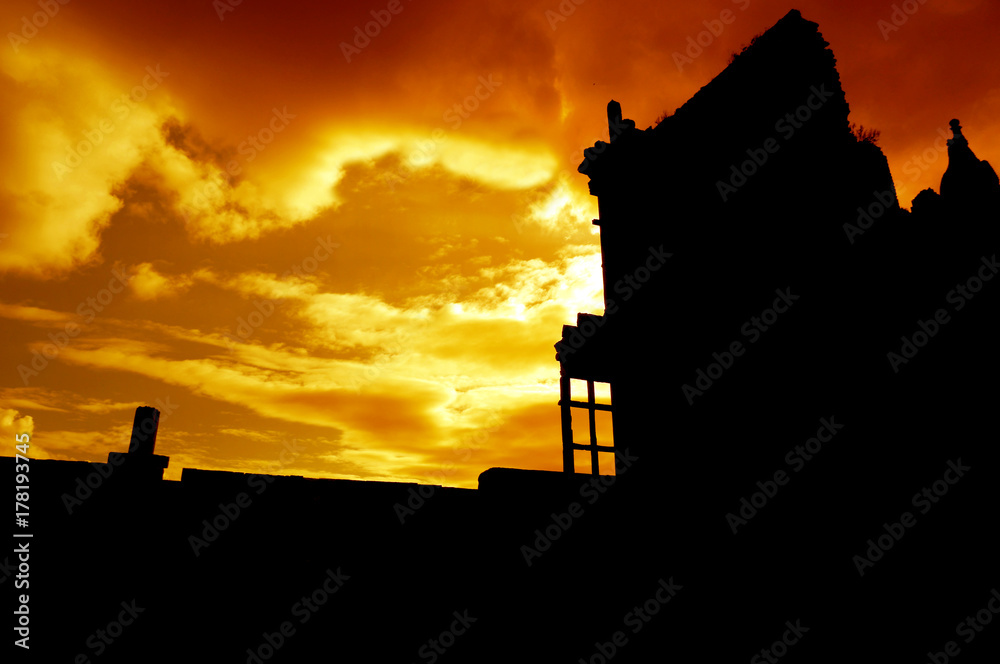 Abandoned ruined building at sunset