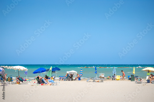 white beaches italy. sea sky people umbrellas sun beds. © makam1969