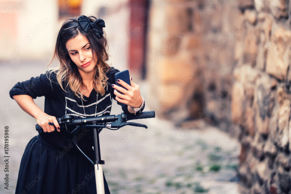 Lifestyle details - portrait of woman taking selfie with smartphone, relaxing on electric scooter
