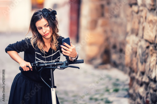 Wallpaper Mural Lifestyle details - portrait of woman taking selfie with smartphone, relaxing on electric scooter Torontodigital.ca