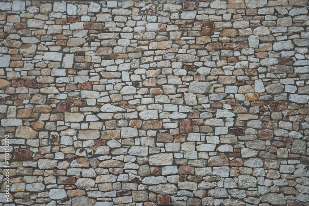 Stone wall background of colorful stones with matt film effect