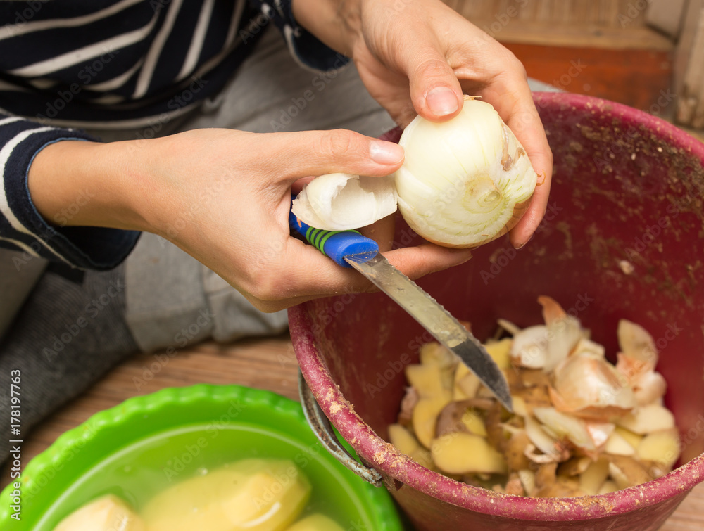 girl cleans the onions in the kitchen girl cleans the onions in the kitchen