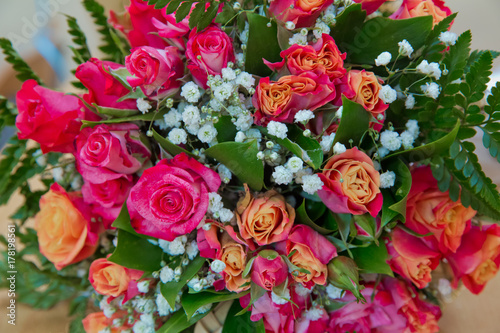 Closeup shot of red bouquet of roses  peonies  pomegranates. Love and passion symbol. Anniversary or birthday gift for girl.