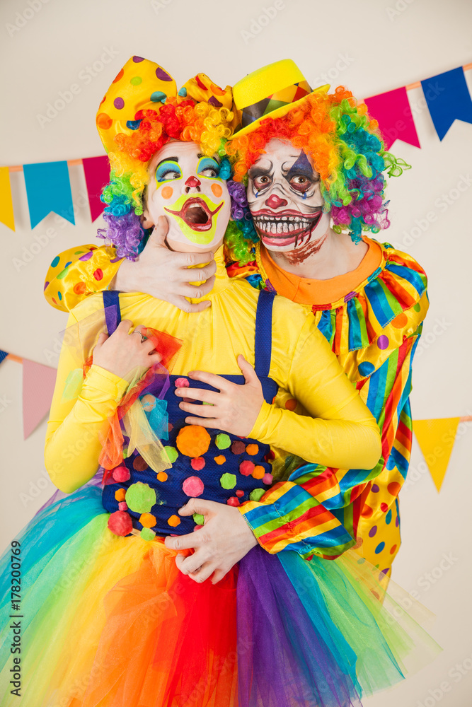 a terrible clown and a good clown. Halloween. The crazy clown and clowness.