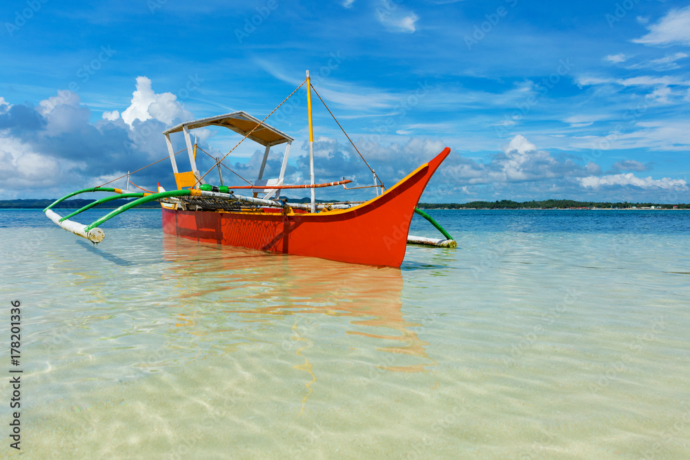 Traditional fishing boat on pristine beach