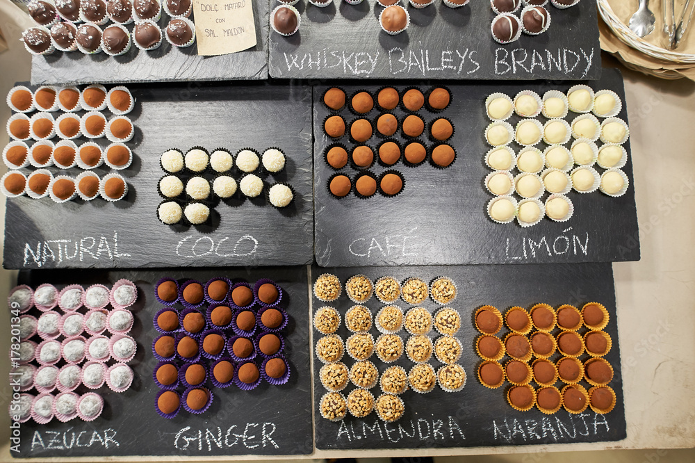Chocolate confectionary on stone plates with description Chocolate confectionary on stone plates with description