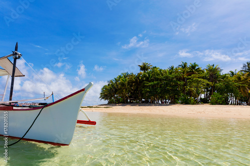 Tropical Guyam Island with traditional fishing boats photo