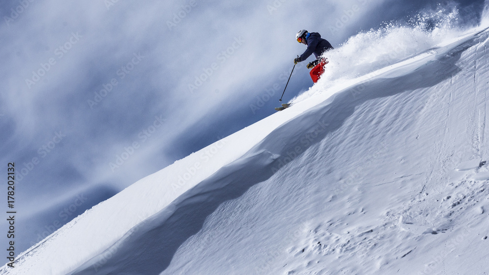 freeride skier goind down steep terrain