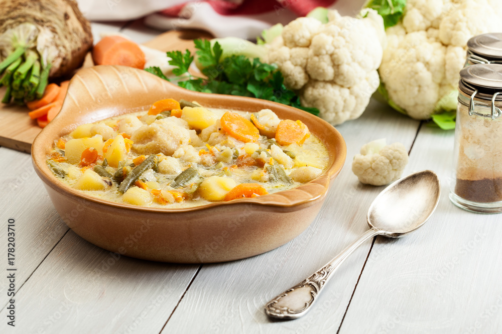 Vegetable soup with ingredients carrot, cauliflower, potato and Vegetable soup with ingredients carrot, cauliflower, potato and