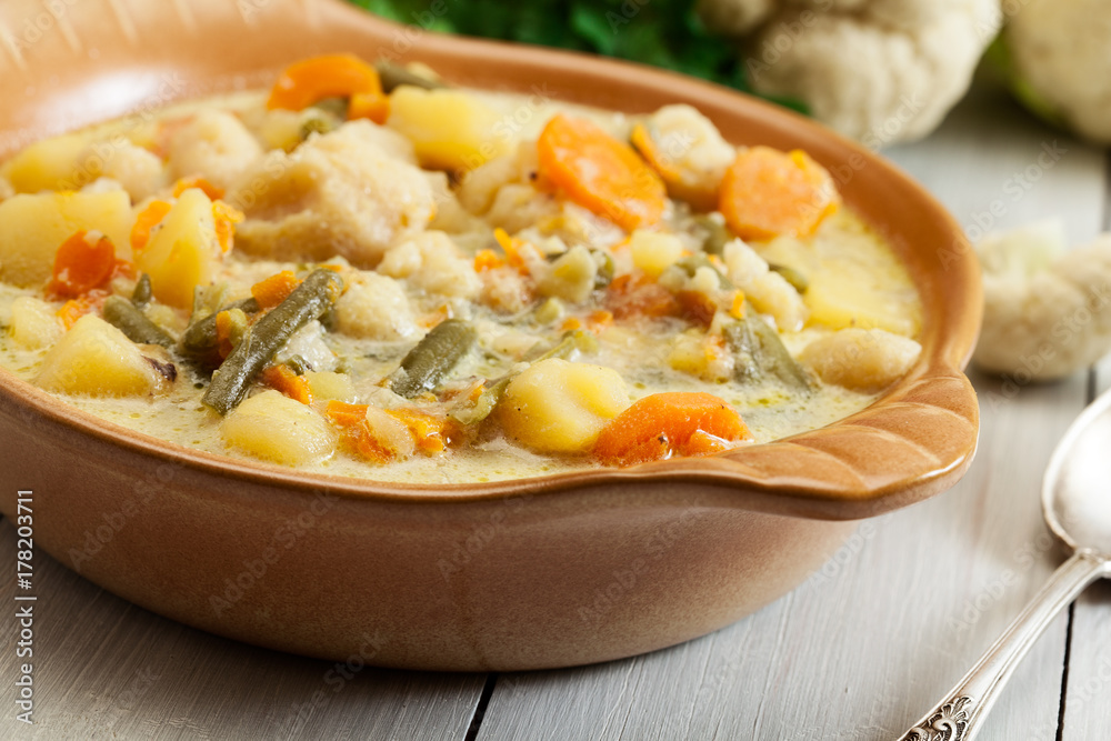 Vegetable soup with ingredients carrot, cauliflower, potato and Vegetable soup with ingredients carrot, cauliflower, potato and