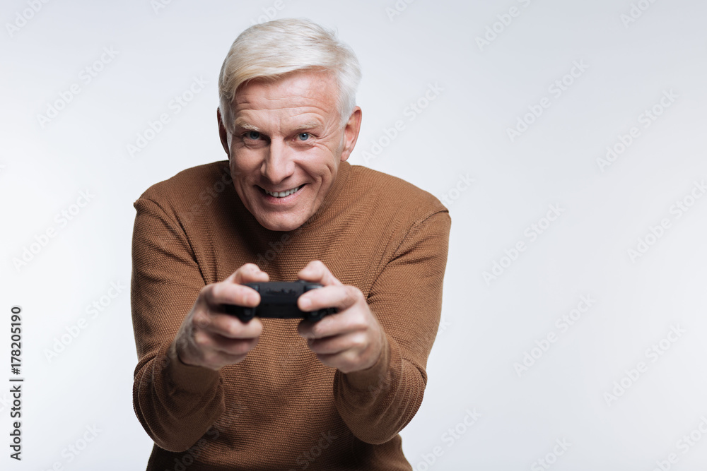 Excited senior man playing video game Excited senior man playing video game