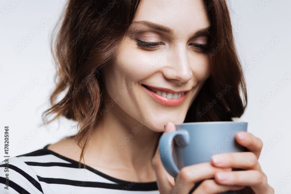 Close up of beautiful woman smelling coffee aroma Close up of beautiful woman smelling coffee aroma