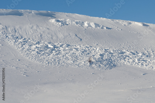 An avalanche of snow came down from the hill.