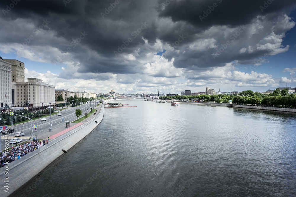 Panoramic view of Moskva river with river buses from Novoandreevskiy Bridge. Krymsky bridge and Cathedral of Christ the Savior on the horizon, urban landscape on spring evening in Moscow, Russia
