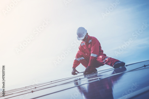 engineer checking job routine of labor working on cleaning solar panel at outside ; operation working on preventive and maintenance in solar power plant for great efficiency