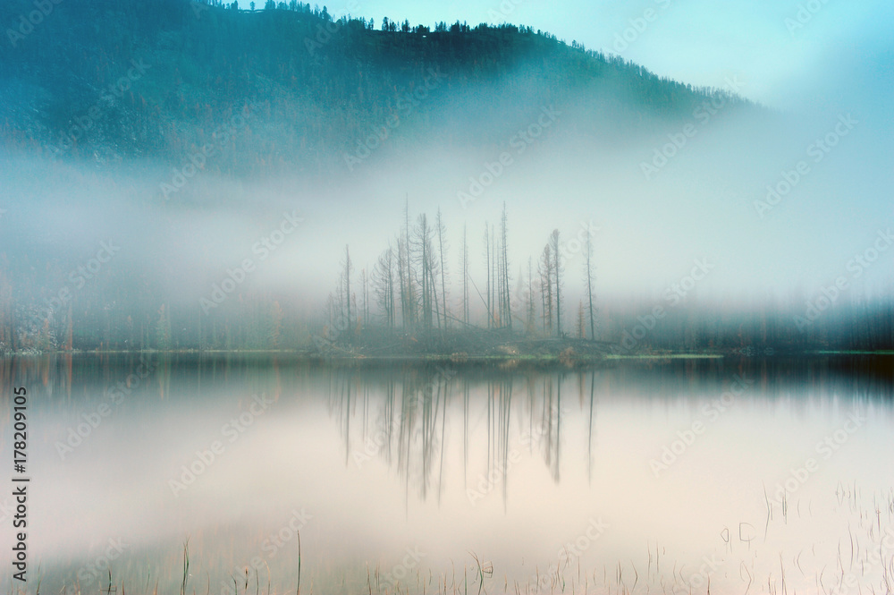 Fog over Lake Arasan. Lake Arasan is located in the territory of the Katon-Karagai district of the East Kazakhstan region of the Republic of Kazakhstan. Fog over Lake Arasan. Lake Arasan is located in the territory of the Katon-Karagai district of the East Kazakhstan region of the Republic of Kazakhstan.