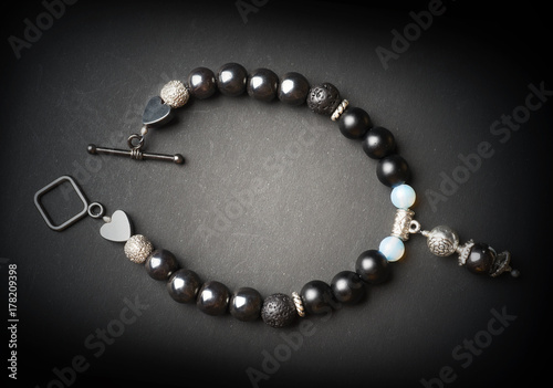 jewel bracelet with semipreciouse stones at black background photo