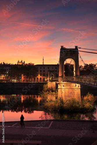 Sunset at the iluminated Passerelle du College over the Rhone river in Lyon, France.