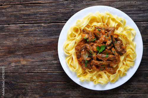 tasty pasta with beef stroganoff stew photo