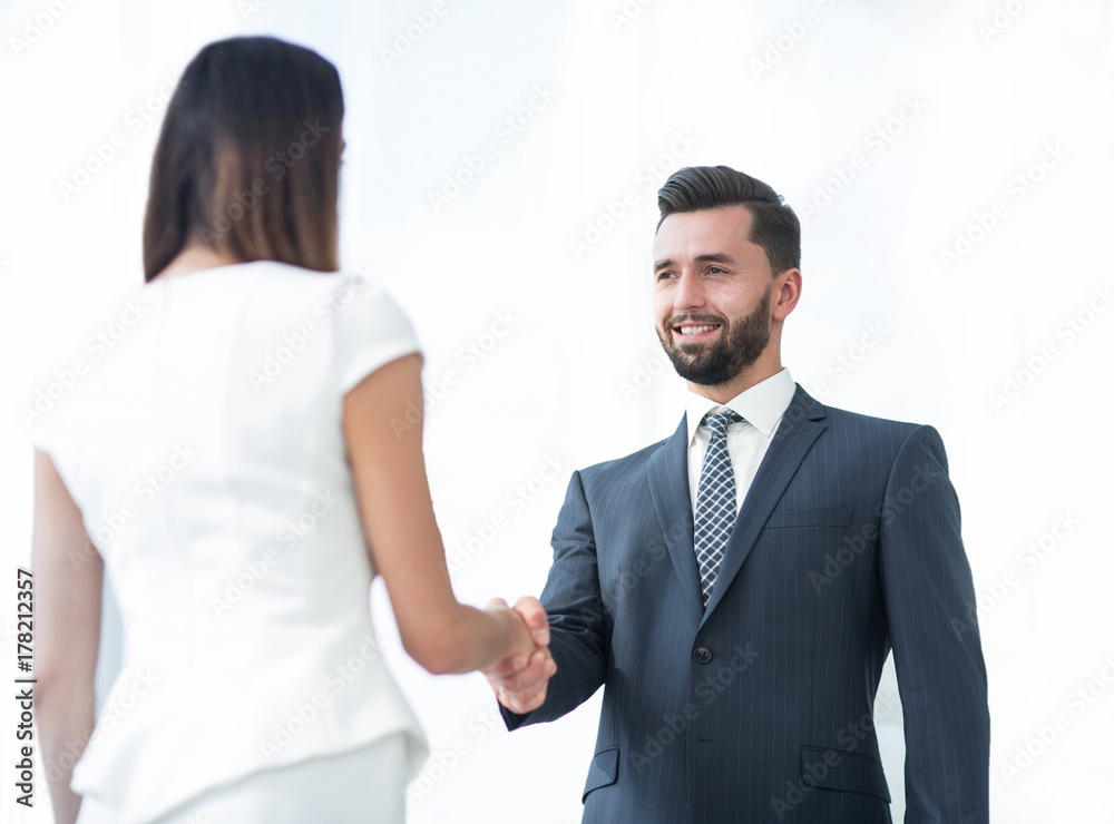 An attractive business man and woman team shaking hands An attractive business man and woman team shaking hands
